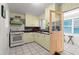 Functional kitchen features a gas range and ample countertop space for meal preparation and dining at 61 E Bayshore Dr, Port Orange, FL 32127