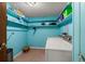 Bright laundry room features shelving, utility sink and washer/dryer at 61 E Bayshore Dr, Port Orange, FL 32127