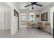 Bright living room with tile flooring, ceiling fan, seating, and open doorway at 61 E Bayshore Dr, Port Orange, FL 32127
