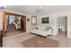 Inviting living room featuring tile floors, a comfortable white sofa, and seamless access to other living spaces at 61 E Bayshore Dr, Port Orange, FL 32127