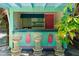 Outdoor bar with ample seating in a verdant tropical setting at 61 E Bayshore Dr, Port Orange, FL 32127