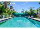 Relaxing backyard pool area with chairs offers a tranquil retreat and serene outdoor experience at 61 E Bayshore Dr, Port Orange, FL 32127