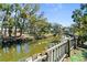 Scenic waterfront view showcases lush greenery and a charming canal with private boat dock at 61 E Bayshore Dr, Port Orange, FL 32127