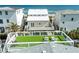 Aerial view of home with rooftop deck, lush green lawn, and ocean view at 6531 Turtlemound Rd, New Smyrna Beach, FL 32169