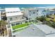 Aerial view of home with rooftop deck, lush green lawn, and ocean view at 6531 Turtlemound Rd, New Smyrna Beach, FL 32169