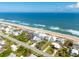 Aerial view of a coastal neighborhood, showcasing beautiful homes near the beach and ocean at 6531 Turtlemound Rd, New Smyrna Beach, FL 32169