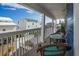 Comfortable balcony with wicker furniture and a view of the neighboring beach houses at 6531 Turtlemound Rd, New Smyrna Beach, FL 32169