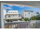 Balcony view showcasing nearby homes and lush greenery, offering a glimpse of the neighborhood charm at 6531 Turtlemound Rd, New Smyrna Beach, FL 32169