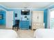 Bright bedroom featuring two queen beds, a TV and dresser with balcony access at 6531 Turtlemound Rd, New Smyrna Beach, FL 32169