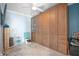 Bedroom features a built-in closet with frosted glass doors, ceiling fan, and tile flooring at 6531 Turtlemound Rd, New Smyrna Beach, FL 32169
