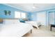 Bedroom with two beds, tile floors, and a ceiling fan at 6531 Turtlemound Rd, New Smyrna Beach, FL 32169