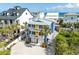 Charming multi-story home with vibrant blue exterior, complemented by well-maintained landscaping and inviting curb appeal at 6531 Turtlemound Rd, New Smyrna Beach, FL 32169
