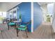 Charming blue exterior with a covered patio and comfortable wicker seating, perfect for enjoying the outdoors at 6531 Turtlemound Rd, New Smyrna Beach, FL 32169