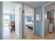 Hallway view looking into a bedroom, showing the tile flooring and blue painted walls at 6531 Turtlemound Rd, New Smyrna Beach, FL 32169