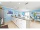 Open-concept kitchen with granite counters flowing into a spacious living area, perfect for entertaining at 6531 Turtlemound Rd, New Smyrna Beach, FL 32169
