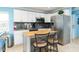 Bright kitchen with white cabinets, butcher block island, stainless steel appliances, and modern finishes at 6531 Turtlemound Rd, New Smyrna Beach, FL 32169