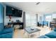 Bright living room featuring sliding doors, tile flooring, tv, and foosball table at 6531 Turtlemound Rd, New Smyrna Beach, FL 32169