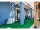 Covered patio features a hammock, artificial turf, and outdoor seating under the raised porch at 6531 Turtlemound Rd, New Smyrna Beach, FL 32169