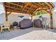 Outdoor kitchen with a covered pergola, featuring an outdoor grill and dining area at 6531 Turtlemound Rd, New Smyrna Beach, FL 32169