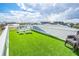 Spacious roof deck featuring artificial turf, seating, and a beautiful view of the community and the surrounding area at 6531 Turtlemound Rd, New Smyrna Beach, FL 32169