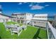Relax on this rooftop deck with turf and chairs, offering panoramic views of the surrounding neighborhood and ocean at 6531 Turtlemound Rd, New Smyrna Beach, FL 32169