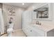 Bathroom boasting white cabinetry, marble countertop, framed mirror, tile floors, and a toilet at 701 Kristina Ct, Port Orange, FL 32127