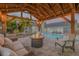 A nighttime view of a gazebo with fire pit and pool, creating a relaxing backyard oasis at 701 Kristina Ct, Port Orange, FL 32127