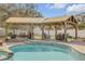 Outdoor pool and patio area features a charming gazebo with lounge furniture at 701 Kristina Ct, Port Orange, FL 32127