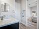 Partial view of a bathroom with a sink with granite counters and access to the bedroom at 743 Aldenwood Trl, New Smyrna Beach, FL 32168