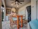 Outdoor kitchen with a stainless steel grill and dining seating with a fan overhead at 743 Aldenwood Trl, New Smyrna Beach, FL 32168