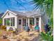 Inviting back patio with a stone floor, comfortable seating, an outdoor grill, and lush tropical surroundings at 751 Pine Shores Cir, New Smyrna Beach, FL 32168