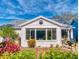 Inviting back patio with a stone floor, comfortable seating, an outdoor grill, and lush tropical surroundings at 751 Pine Shores Cir, New Smyrna Beach, FL 32168