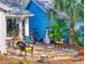 Inviting back patio with a stone floor, comfortable seating, an outdoor grill, and lush tropical surroundings at 751 Pine Shores Cir, New Smyrna Beach, FL 32168