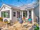 Inviting back patio with a stone floor, comfortable seating, and a lush tropical surroundings at 751 Pine Shores Cir, New Smyrna Beach, FL 32168