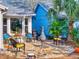 Inviting back patio with a stone floor, comfortable seating, an outdoor grill, and lush tropical surroundings at 751 Pine Shores Cir, New Smyrna Beach, FL 32168