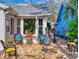 Inviting back patio with a stone floor, comfortable seating, an outdoor grill, and lush tropical surroundings at 751 Pine Shores Cir, New Smyrna Beach, FL 32168