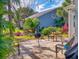 Secluded backyard retreat featuring a stone patio, lush landscaping, and comfortable seating at 751 Pine Shores Cir, New Smyrna Beach, FL 32168