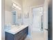 Well-lit bathroom showcasing a sleek vanity with double sinks and modern fixtures at 751 Pine Shores Cir, New Smyrna Beach, FL 32168