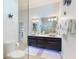 This modern bathroom boasts a large vanity with dual vessel sinks and under-cabinet lighting at 751 Pine Shores Cir, New Smyrna Beach, FL 32168
