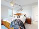 Well-lit bedroom featuring a wooden bed frame, ceiling fan, and a private bathroom at 751 Pine Shores Cir, New Smyrna Beach, FL 32168