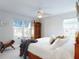 Bright bedroom with a large bed, ceiling fan, and windows for natural light at 751 Pine Shores Cir, New Smyrna Beach, FL 32168
