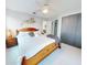 Comfortable bedroom featuring a wooden bed frame, ceiling fan, and a private bathroom at 751 Pine Shores Cir, New Smyrna Beach, FL 32168