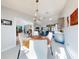 Open-concept dining area flowing into the kitchen, featuring a table set for a meal, and neutral colors at 751 Pine Shores Cir, New Smyrna Beach, FL 32168