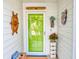 Inviting front entrance featuring a vibrant green door and nautical-themed decor at 751 Pine Shores Cir, New Smyrna Beach, FL 32168