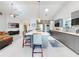 Spacious kitchen with a central island, sleek appliances, and an open layout to the living area at 751 Pine Shores Cir, New Smyrna Beach, FL 32168