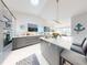 Elegant kitchen with modern gray cabinetry, stainless steel appliances, and large island with seating at 751 Pine Shores Cir, New Smyrna Beach, FL 32168