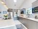 Modern kitchen featuring gray cabinets, stainless steel appliances, a large island and lots of natural light at 751 Pine Shores Cir, New Smyrna Beach, FL 32168
