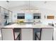 Modern kitchen featuring sleek cabinetry, stainless steel appliances, and a spacious center island with seating at 751 Pine Shores Cir, New Smyrna Beach, FL 32168