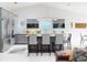 Open kitchen with stainless steel appliances, large island with bar seating, and modern lighting at 751 Pine Shores Cir, New Smyrna Beach, FL 32168