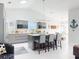 Bright, open-concept kitchen with a vaulted ceiling, center island, stainless appliances and barstool seating at 751 Pine Shores Cir, New Smyrna Beach, FL 32168